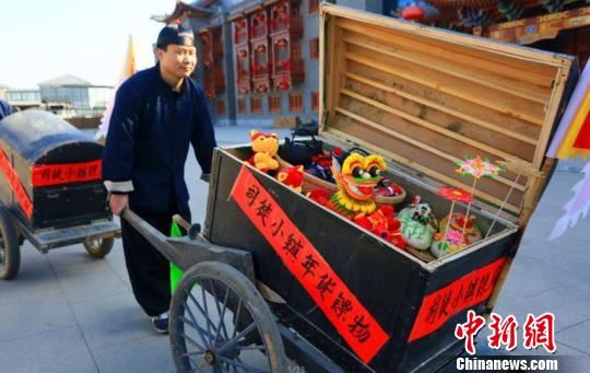 司徒小镇景区挑选了花馍、面塑、山西老陈醋等山西特色年货，由5名镖师押送货物在景区内展演。　李庭耀 摄